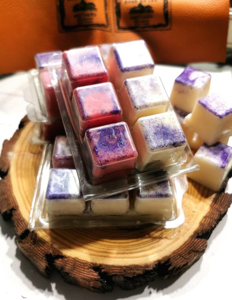 Artisanal hand-crafted wax melts from the Calma range displayed on a pine stand from Bord Du Lac Artisans.
