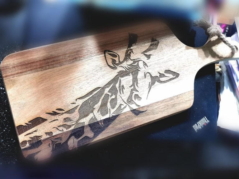 Bespoke laser-engraved acacia serving board with giraffe design from the Safari Collection at Bord Du Lac Artisans.