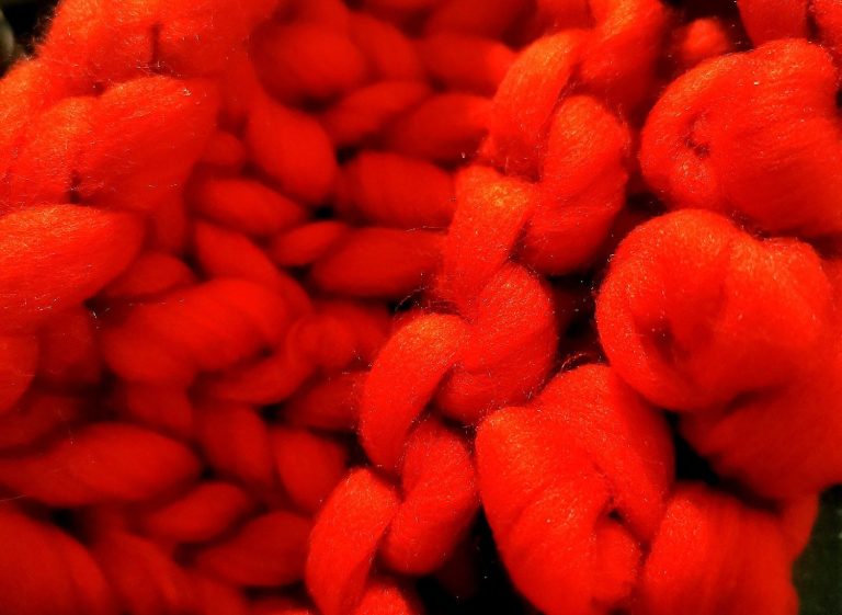 Close-up of a scarlet blanket, chunky pattern from the Adventures in Wool at Bord Du Lac Artisans